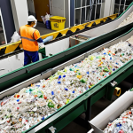 **

A bustling waste sorting facility. Conveyor belts move various types of waste (plastic, paper, glass, metal). Workers in protective gear are sorting the materials. Bins for separate collection are clearly marked. Emphasis on the concept of recycling valuable resources.

**